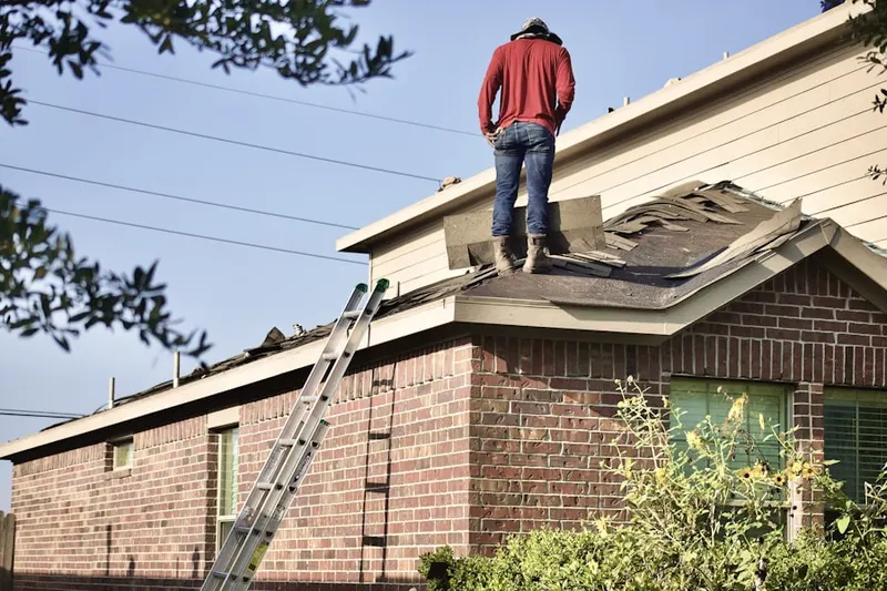 Professional roofer working on a residential roof in North Massapequa
